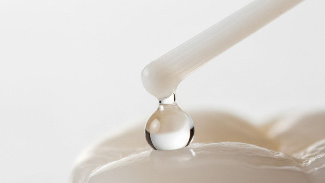 Toothbrush bristle above tooth enamel with water droplet