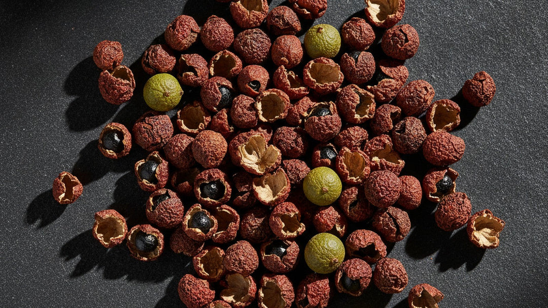 Dried Szechuan peppercorns on dark slate surface