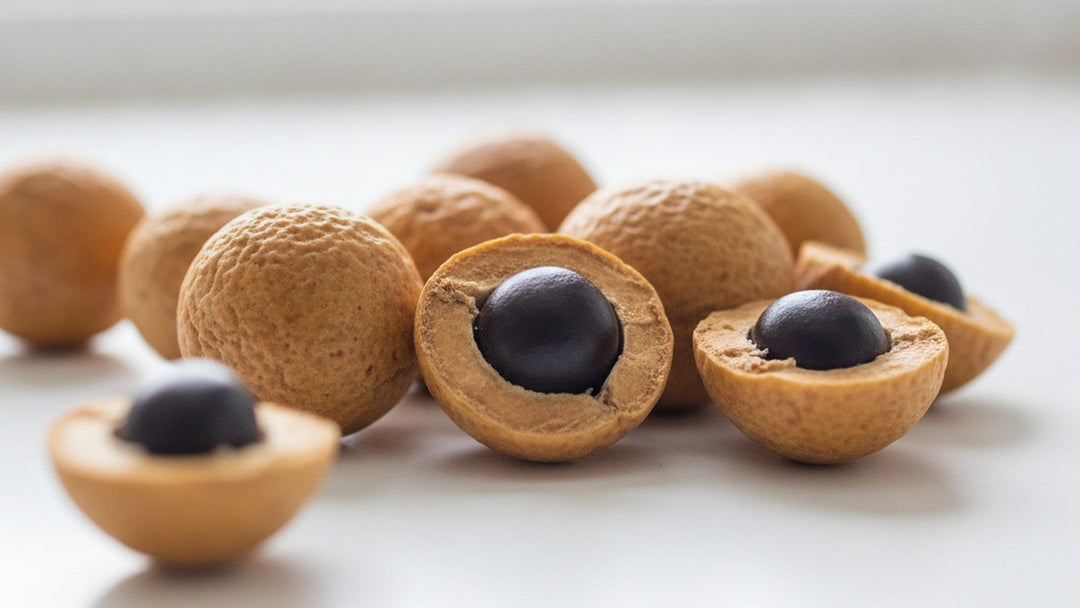 Whole and split soapnuts on white surface