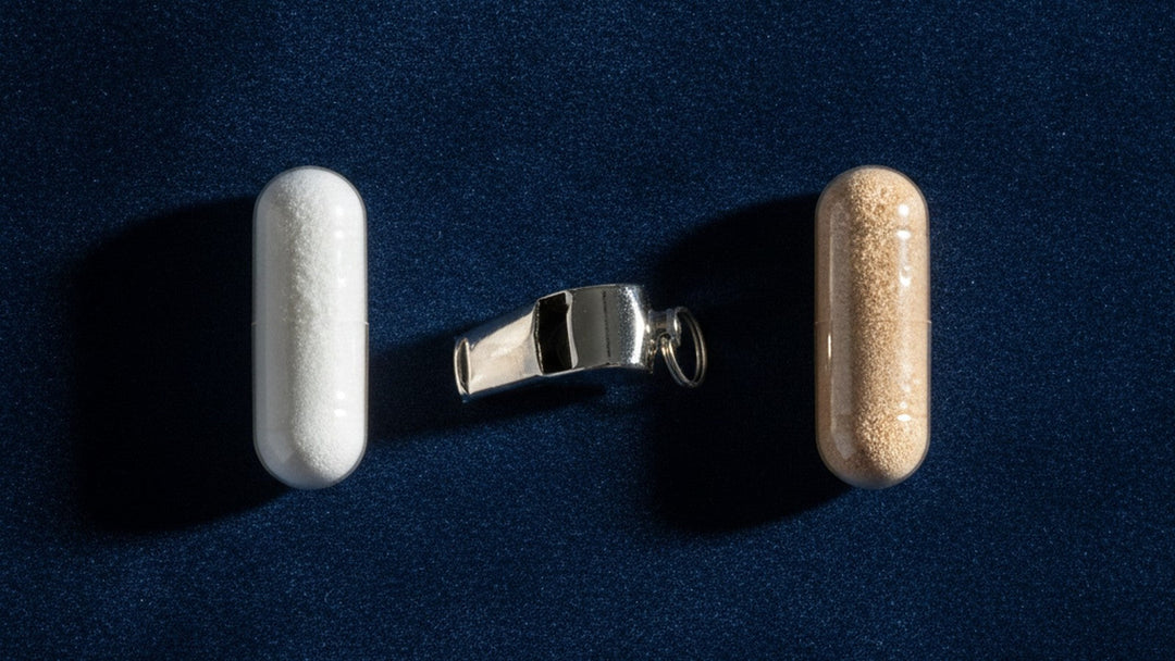 Two supplement capsules positioned like opponents with a whistle between them