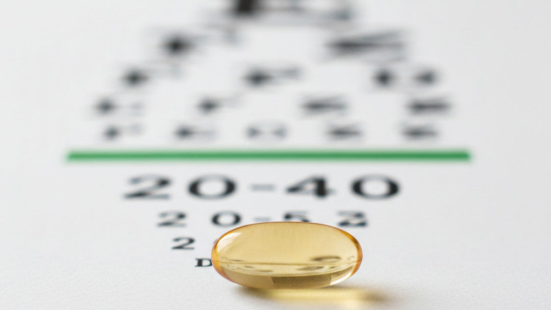 Vitamin E supplement capsule beside eye chart