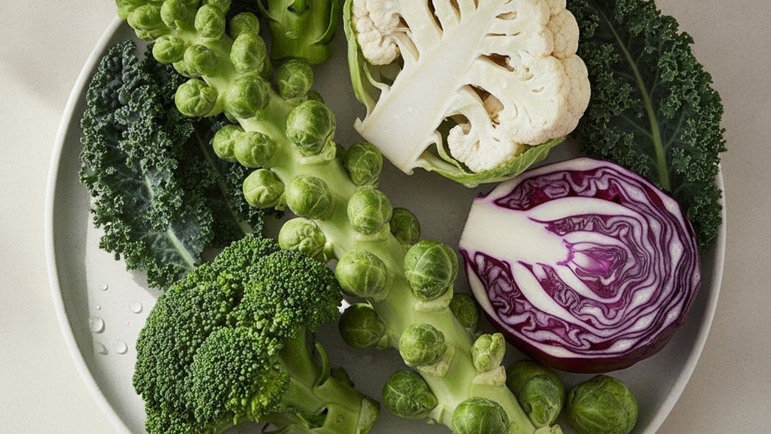 Fresh cruciferous vegetables broccoli, cauliflower, Brussels sprouts, purple cabbage and kale on a pale ceramic plate