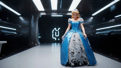 An animated GIF of a sad princess in a tattered dress on a runway. A blue genie appears and, with a magical green thread, instantly transforms her dress into a masterpiece, symbolizing Nature's Way's support for hair, skin, and nails.